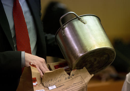 During the trial for Martin Blackwell a lawyer holds a pot they say Blackwell used to pour boiling water on his girlfriend's gay son and his friend as they slept, in Atlanta, Tuesday, Aug. 23, 2016. (AP Photo/John Bazemore)